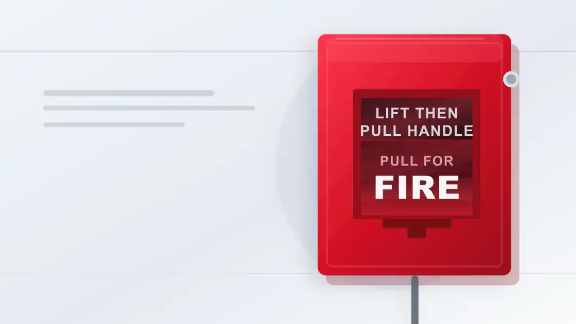Red manual fire alarm call point mounted on a clean commercial wall